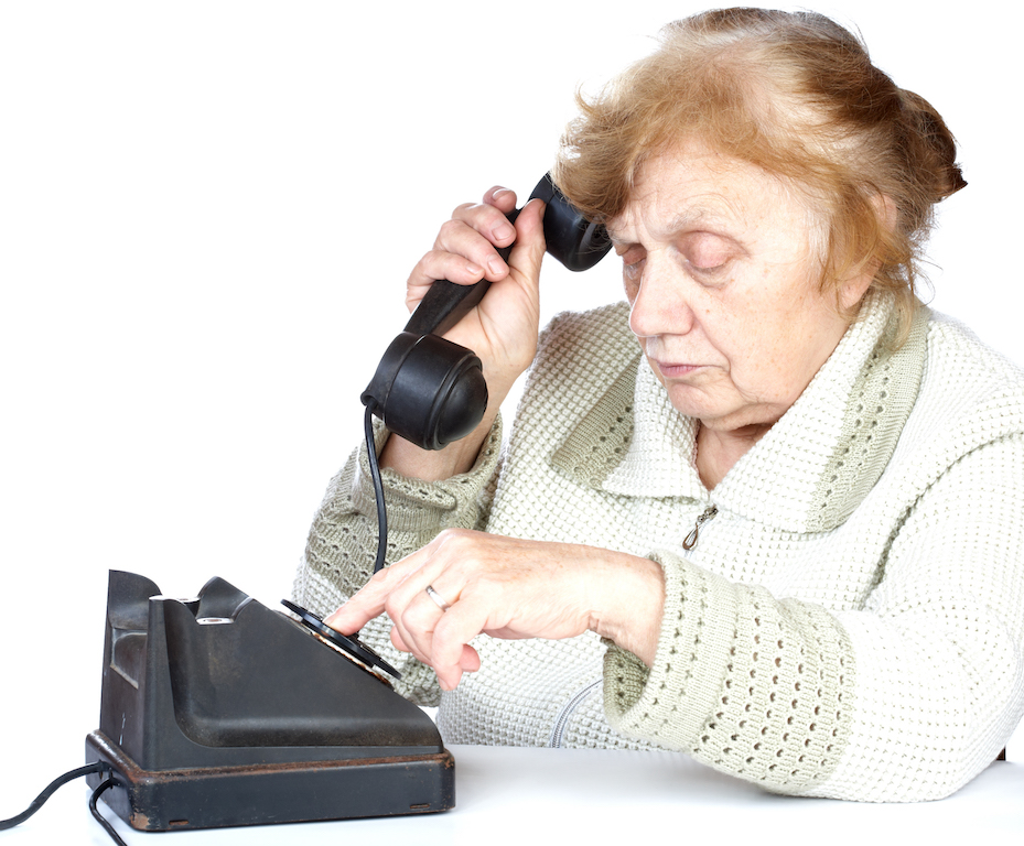 The old woman dials number of phone