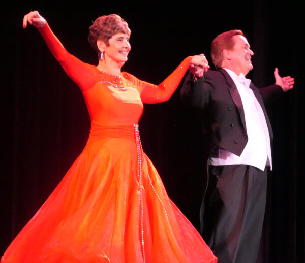 Singer Mark Steven Schmidt and wife Linda Succi take a bow on stage after a waltz