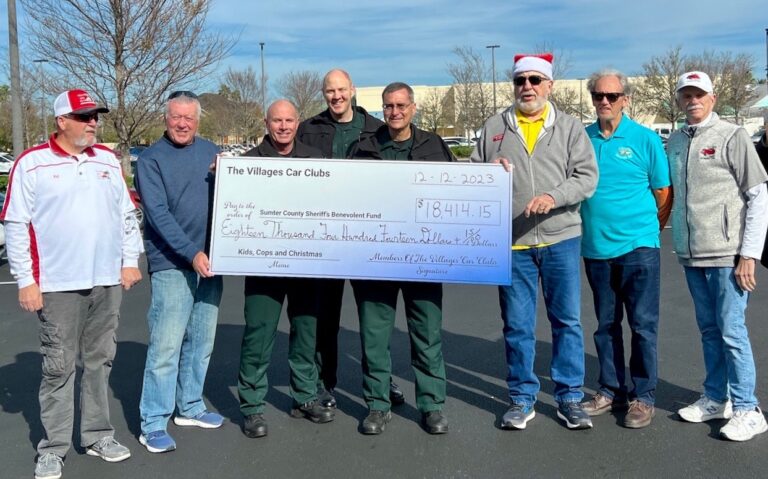 Car clubs presidents present a check for $18,414.15 to the Sumter County Sheriff's Office.