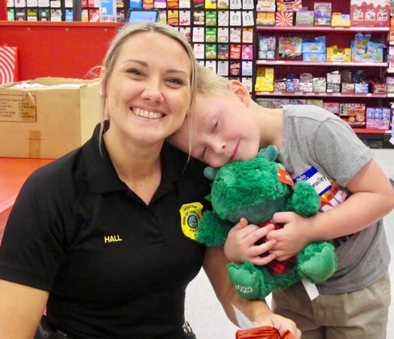 Detective Erica Hll with one of the children on the shopping trip