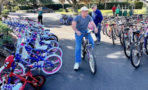 Mike Sadle ,who resides in the Village of Saint Catherines, test rides a bike before it is loaded for transport.