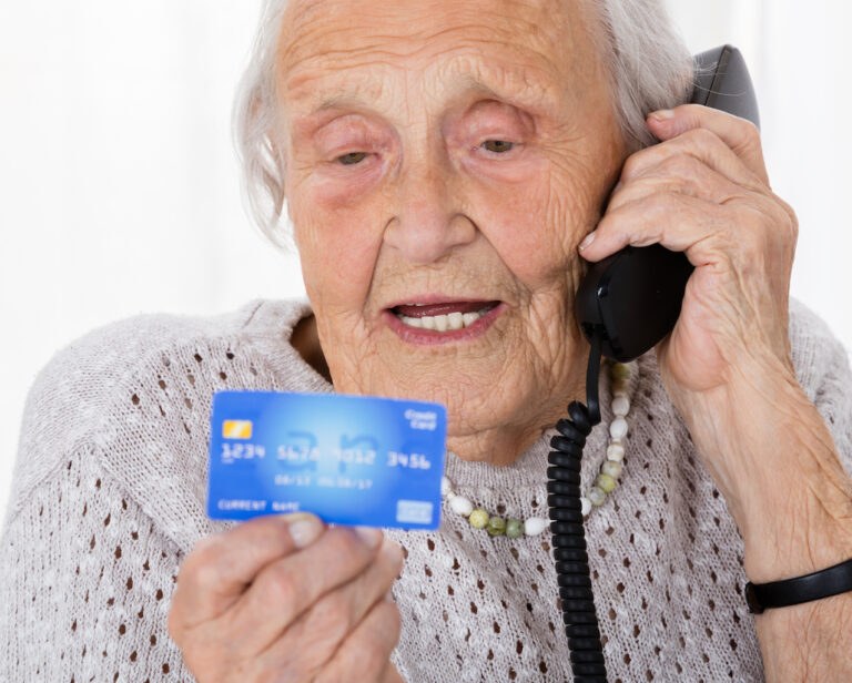 Senior Woman With Credit Card On Phone