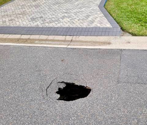 The hole was three to four wide and opened up near a driveway in the Village of Lynnhaven The hole was three to four wide and opened up near a driveway in the Village of Lynnhaven