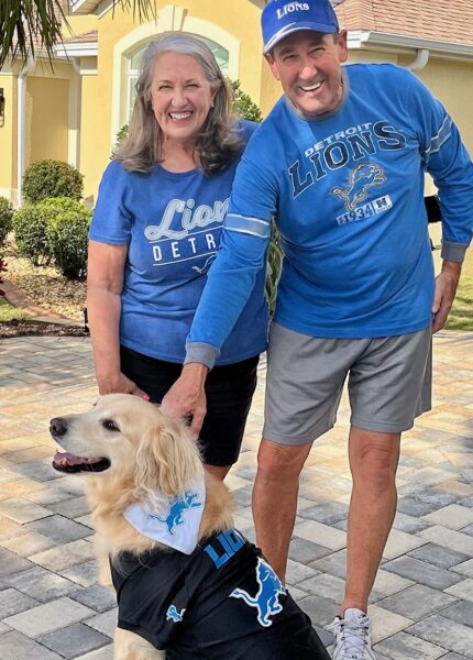 Villagers Greg and Nora Stanbury along with Banjo are dressed and ready for Lions game