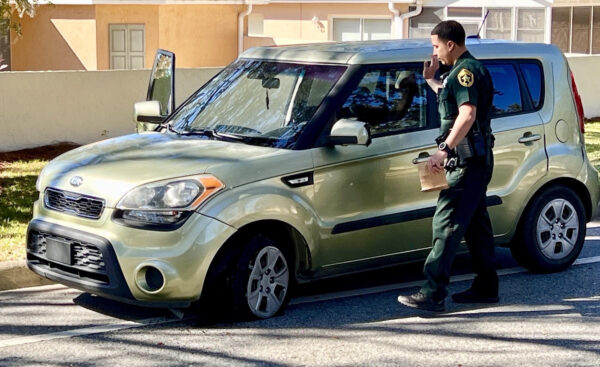 A deputy collects evidence from the car which was used to lead law enforcement on a chase A deputy collects evidence from the car which was used to lead law enforcement on a chase