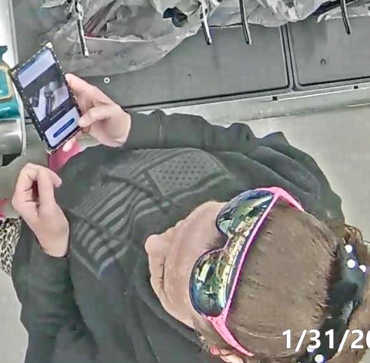 The woman was checking her phone during the trip to Walmart