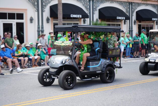 A golf cart decked in shamrocks at 2024 St. Patrick's Day Festival in The Villages