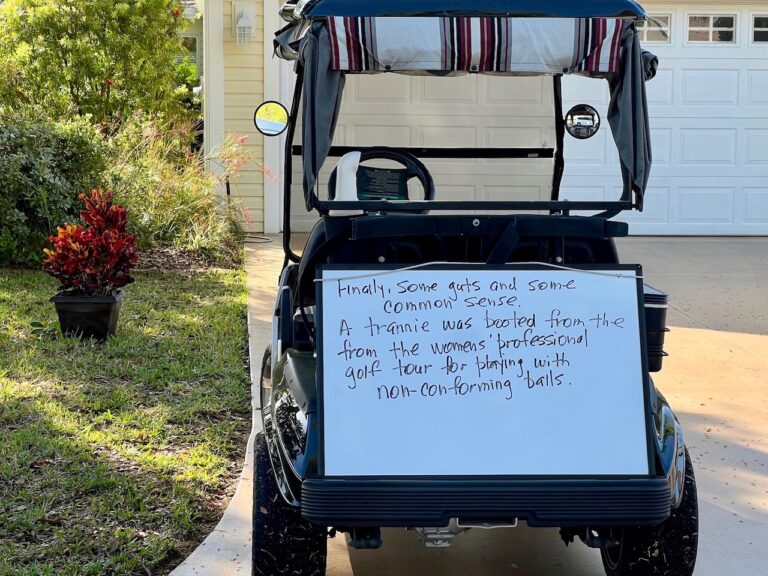 A resident has regularly been display handwritten signs on a white board leaned up against his golf cart