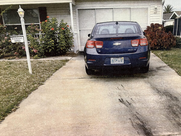 An inoperable vehicle remains in the driveway at 2003 Cipriano Place