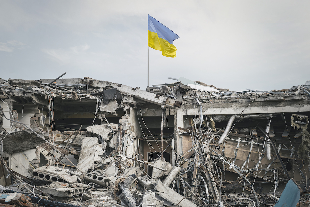 destroyed building. view of the ruins. wreckage of the building and the Ukrainian flag