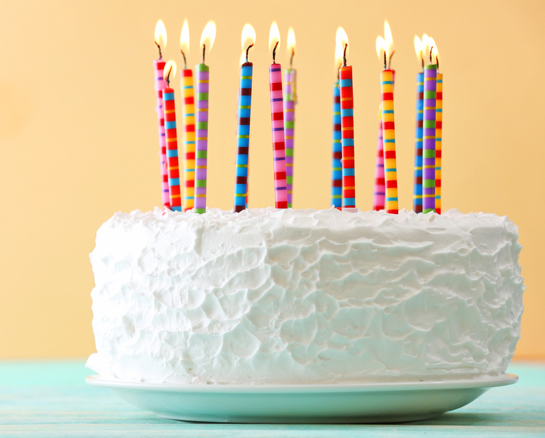 Birthday cake with candles on color background
