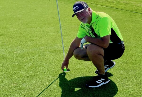 Gil Vaillancourt shows off the spot where he scored the lucky ace