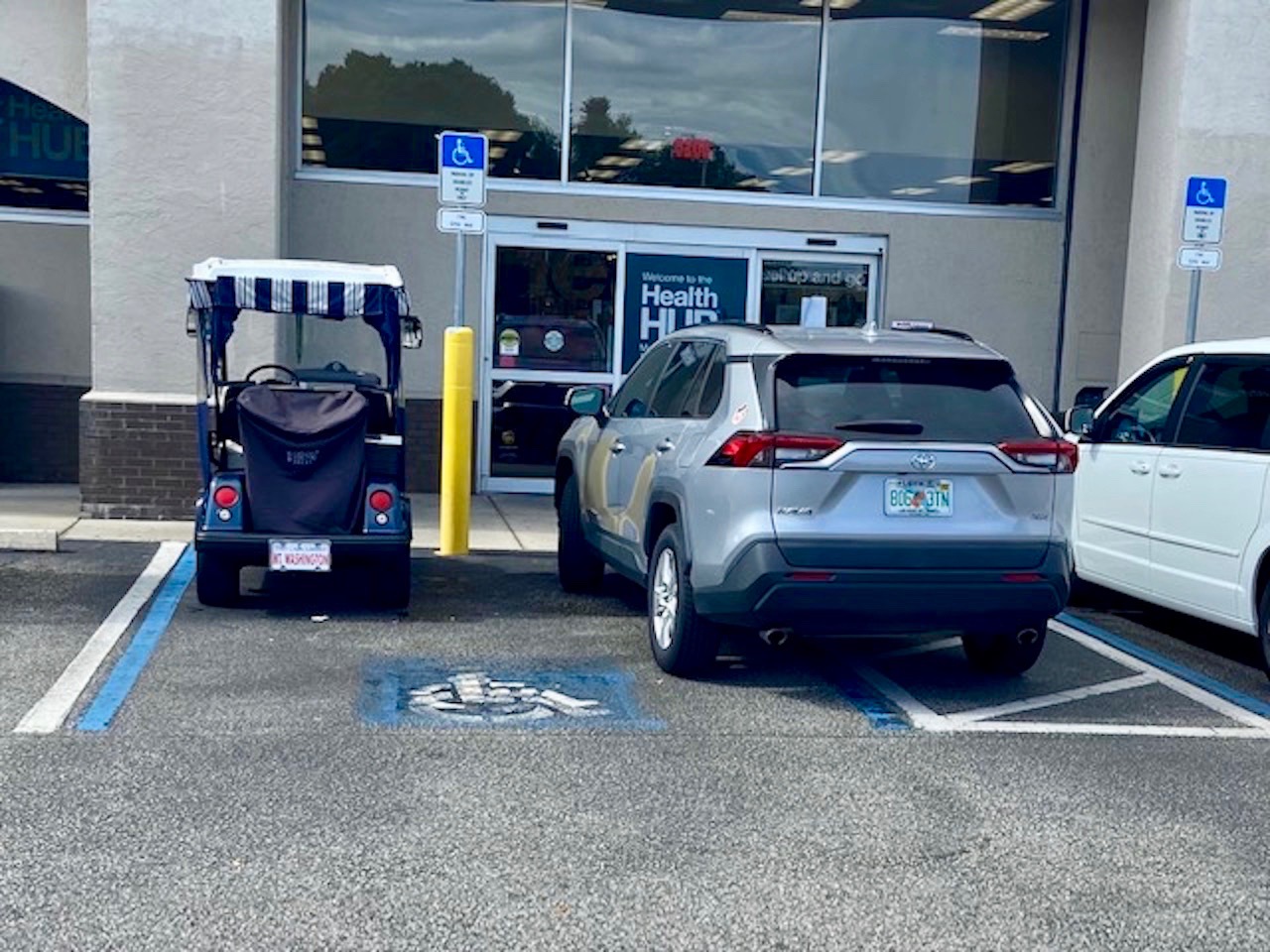 A golf cart and a car share a hanicapped parking spot at CVS on County Road 466 in The Villages