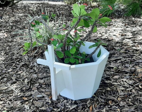 The Andersons have incorporated this little white cross into a planter at their home in The Villages The Andersons have incorporated this little white cross into a planter at their home in The Villages