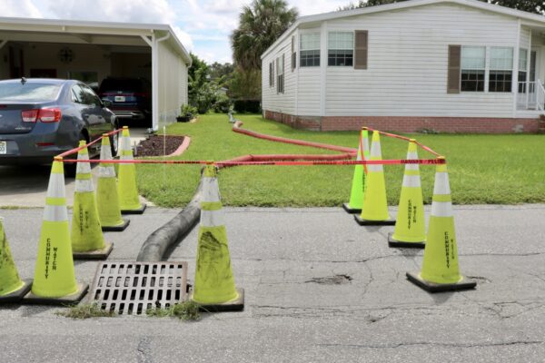 The hose empties into a storm drain on Vermont Avenue which has one lane open. The hose empties into a storm drain on Vermont Avenue which has one lane open.