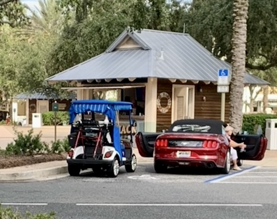 This golf cart and Ford Mustang shared a handicapped spot at Lake Sumter Landing