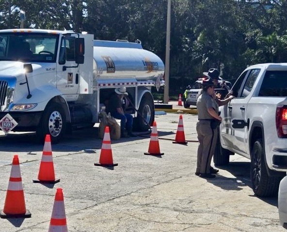 The Florida Highway Patrol was overseeing the distribution of free gasoline at a state run site. The Florida Highway Patrol was overseeing the distribution of free gasoline at a state run site.