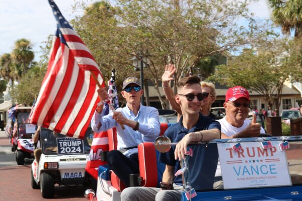 U.S. Sen. Rick Scott, holding flag, rides in a golf cart parade Saturday in The Villages U.S. Sen. Rick Scott, holding flag, rides in a golf cart parade Saturday in The Villages
