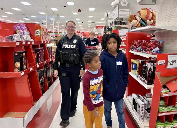 Fruitland Park officer Briana Allen escorts Jabar and his big sister Jewlle through the Target store is search of Christmas presents Fruitland Park officer Briana Allen escorts Jabar and his big sister Jewlle through the Target store is search of Christmas presents