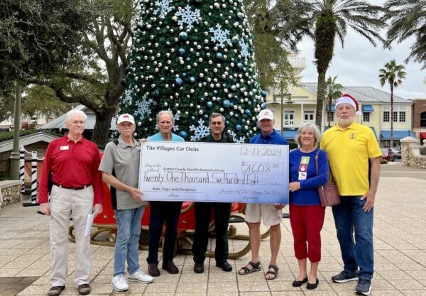 Members of the car clubs in The Villages presented a check to the sheriff s office to support the Kids, Cops and Christmas program Members of the car clubs in The Villages presented a check to the sheriff s office to support the Kids, Cops and Christmas program