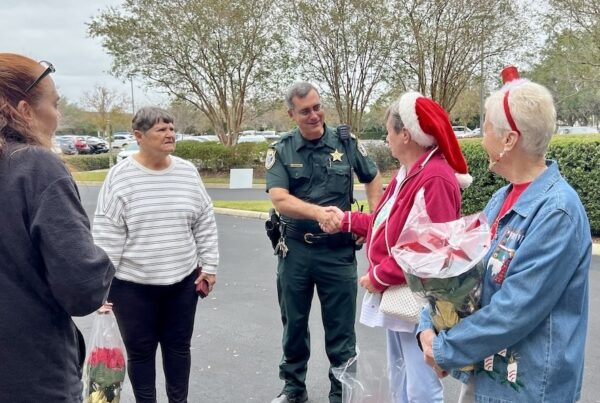 Sumter County Sheriff s Captain Robert Siemer thanks Villager s for their doanations to the Christmas progam.