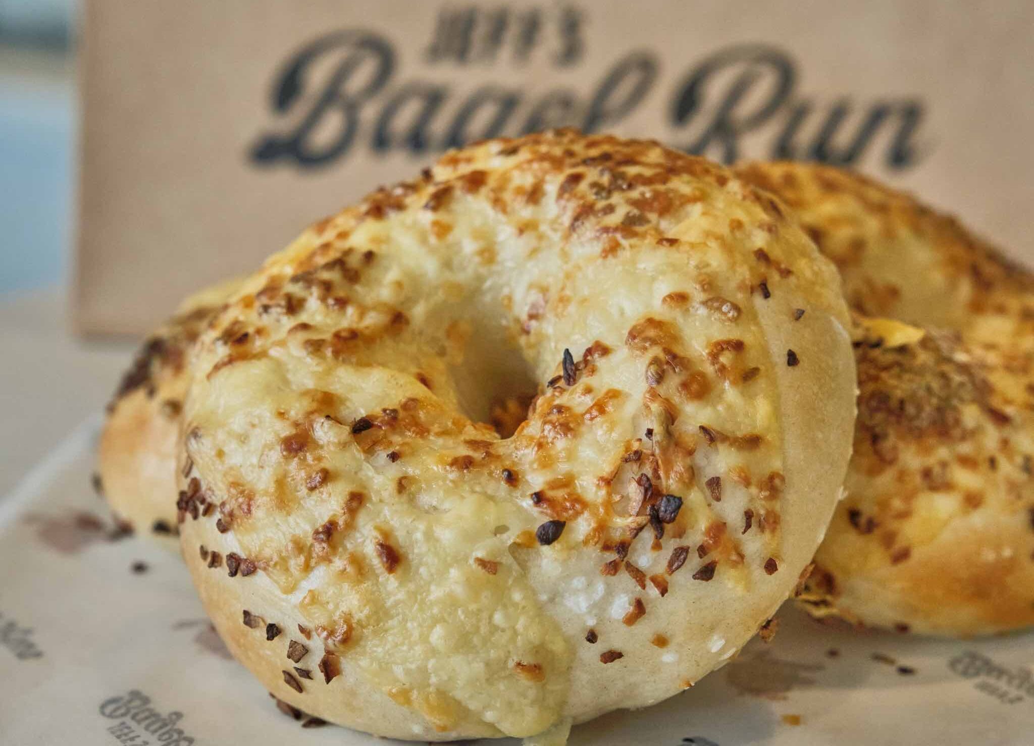 Bagel topped with onion, salt, asiago cheese at Jeff s Bagel Run