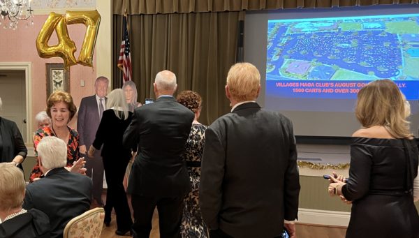 Villagers lined up for the chance to have their pictures taken with President Trump and Melania cutouts during the MAGA event at the Colony Cottage Recreation Center. Villagers lined up for the chance to have their pictures taken with President Trump and Melania cutouts during the MAGA event at the Colony Cottage Recreation Center.