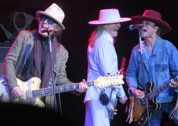 Bassman Tom Petersson sings while Robin Zander center and his son Robin Taylor Zander provide some harmony