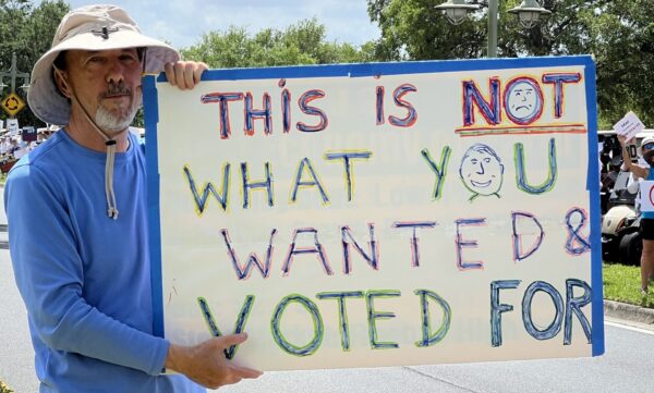 A protester held up a sign at the April 5 rally in The Vllages A protester held up a sign at the April 5 rally in The Vllages