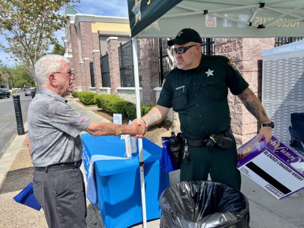 Retired Army colonel John Bercher thanks Deputy Donald Henshaw during the drug collection event Retired Army colonel John Bercher thanks Deputy Donald Henshaw during the drug collection event