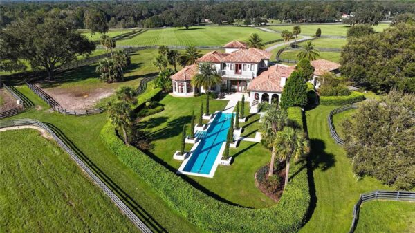 The property features a 75-foot lap pool surrounded by cypress trees. The property features a 75-foot lap pool surrounded by cypress trees.