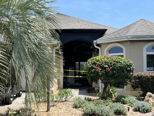 Yellow tape blocked off entry to the front door of the home after the fire Yellow tape blocked off entry to the front door of the home after the fire