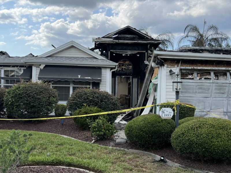 Yellow tape encirdles the home which erupted in flames Saturday in the Village of Winifred