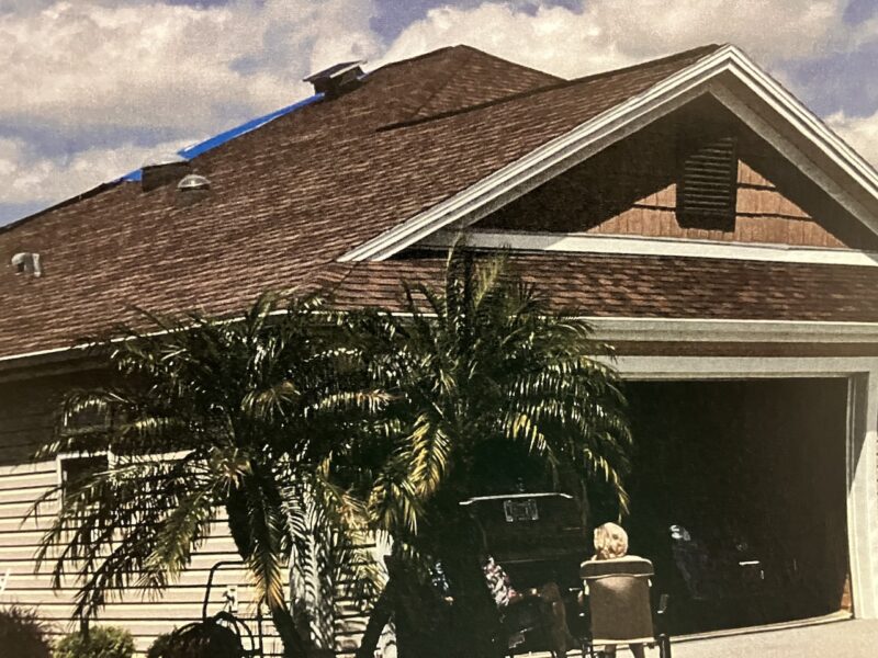 A blue tarp is visible at the rear section of this roof at 431 Jungle Plum Way in the Village of Osceola Hills