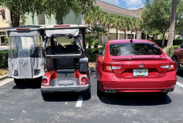 These golf carts and the red car were parked a little too close for comfort These golf carts and the red car were parked a little too close for comfort