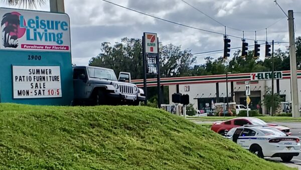 The driver of this silver Jeep, at left, was taken into custody by law enforcement.