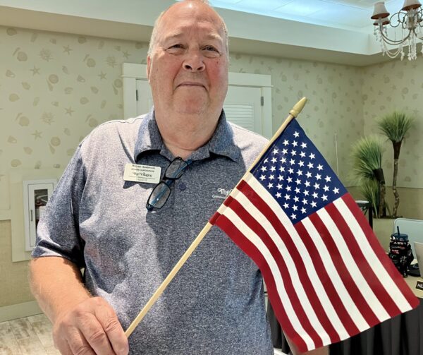 Wayne Anderson holds an American flag similar to one a Villager was asked to remvoe from his yard. Wayne Anderson holds an American flag similar to one a Villager was asked to remvoe from his yard.