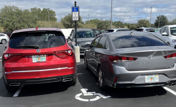 These cars, with no handicapped license plates and no visible handicapped placard, were crammed together in a handicapped parking spot These cars, with no handicapped license plates and no visible handicapped placard, were crammed together in a handicapped parking spot