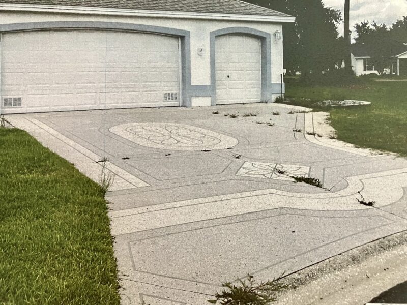 Weeds are growing in the cracks of this driveway on Hopewell Street in the Village of Belle Aire