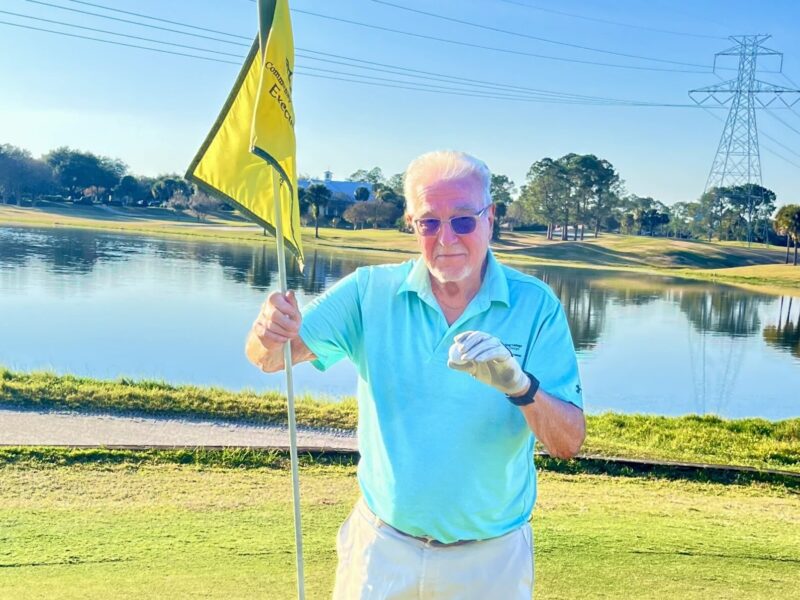 Peter Thanas shows off his golf ball after scoring the lucky ace