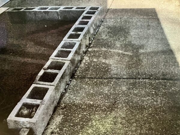 Concrete blocks line the front sidewalk at the Yerramillis patio villa