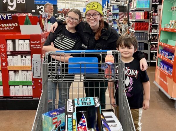 Maria Greene, 13, at left, and her six year old brother were escorted by Deputy Bibbo who really exhibited holiday cheer..
