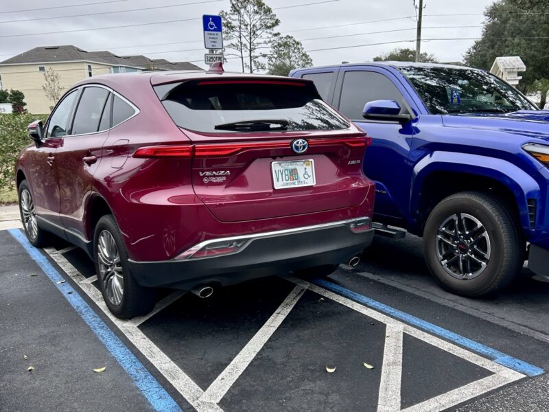 This Toyota Venza has a handicapped plate but is improperly parked in a handicapped accommodation zone.