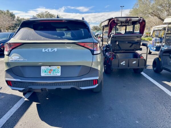 This car and golf cart were squeezed in together at the Mulberry Grove Recreation Center This car and golf cart were squeezed in together at the Mulberry Grove Recreation Center