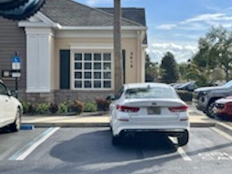 This car was parked half in a Golf Cart Only space at a Wells Fargo bank branch in The Villages