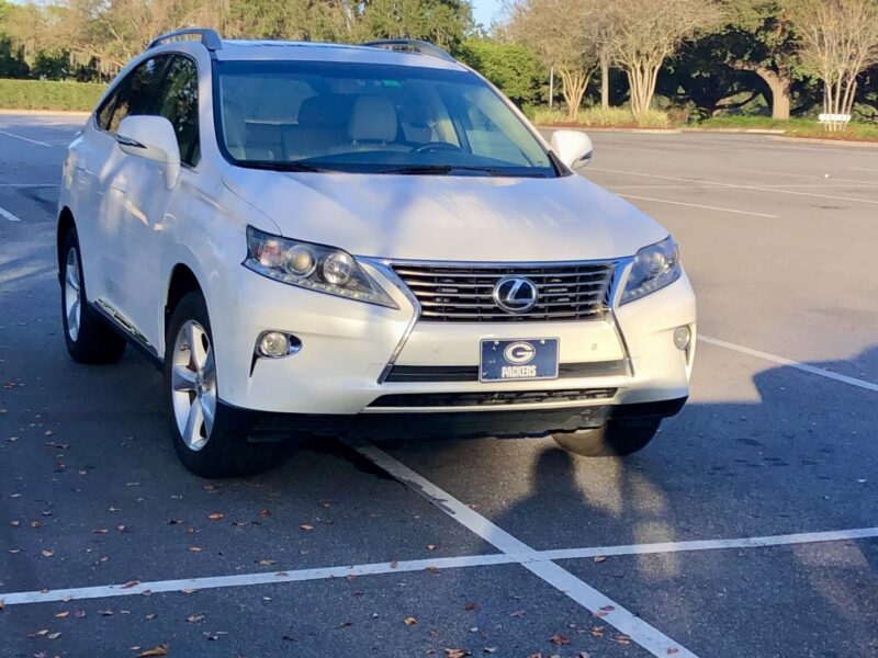 This Lexus with a Green Bay Packers plate was straddling the line in a parking lot in The Villages