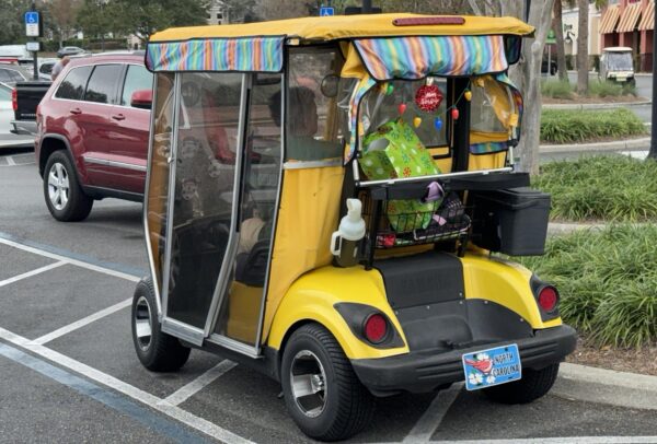 This golf cart was parked in the handicapped accommodation This golf cart was parked in the handicapped accommodation
