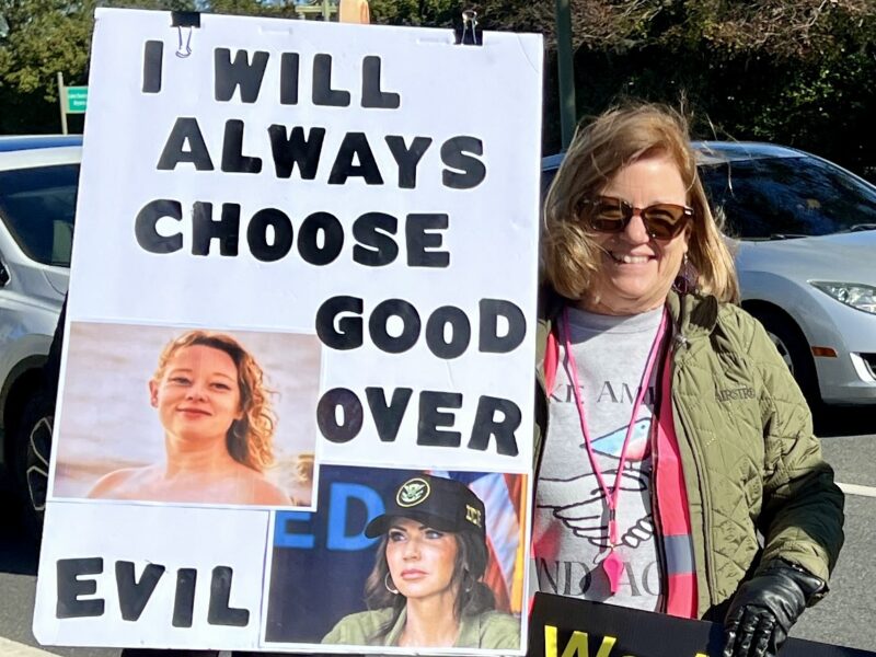 Villager Karyn O Donnell held up a sign during the demonstration