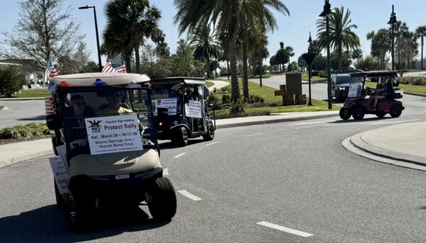 Golf carts carvanned to promote the upcomimg No Kings Rally Golf carts carvanned to promote the upcomimg No Kings Rally