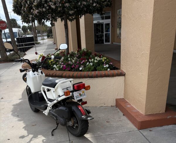The person riding this scooter found some special sidewalke parking at La Plaza Grande The person riding this scooter found some special sidewalke parking at La Plaza Grande